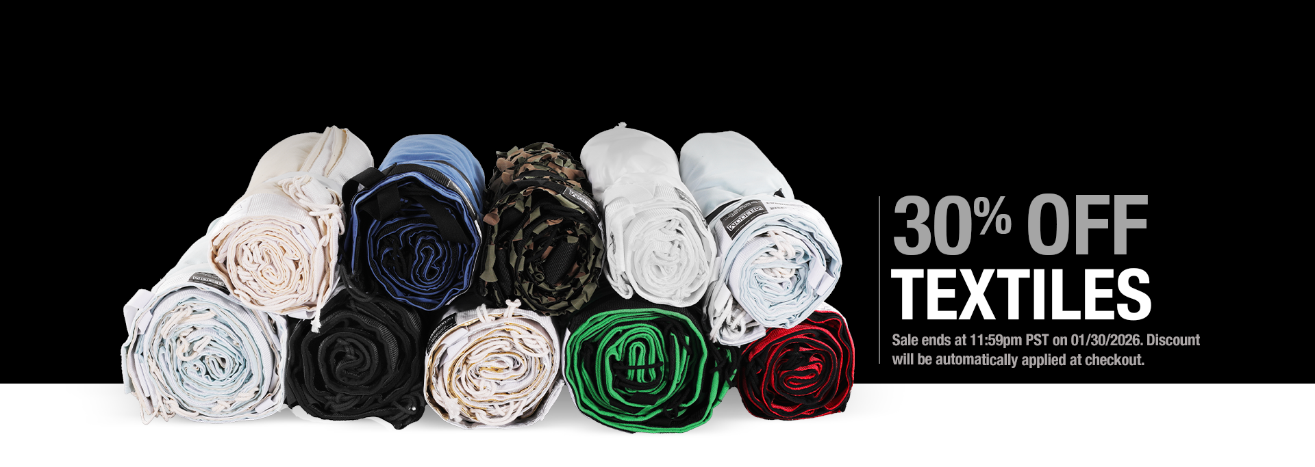 Rolled-up fabrics in various colors with a 30% off textiles offer on a black background.