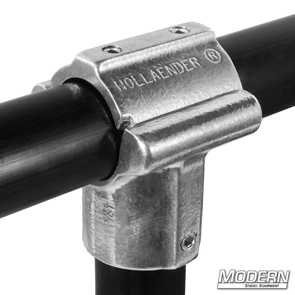 A silver Hollaender split tee fitting attached to a black pole, displaying the brand name 'HOLLAENDER' on the side.