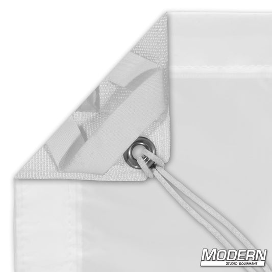 Close-up of a white diffusion textile corner with elastic and ties, including a visible label that reads 'MODERN STUDIO EQUIPMENT'.