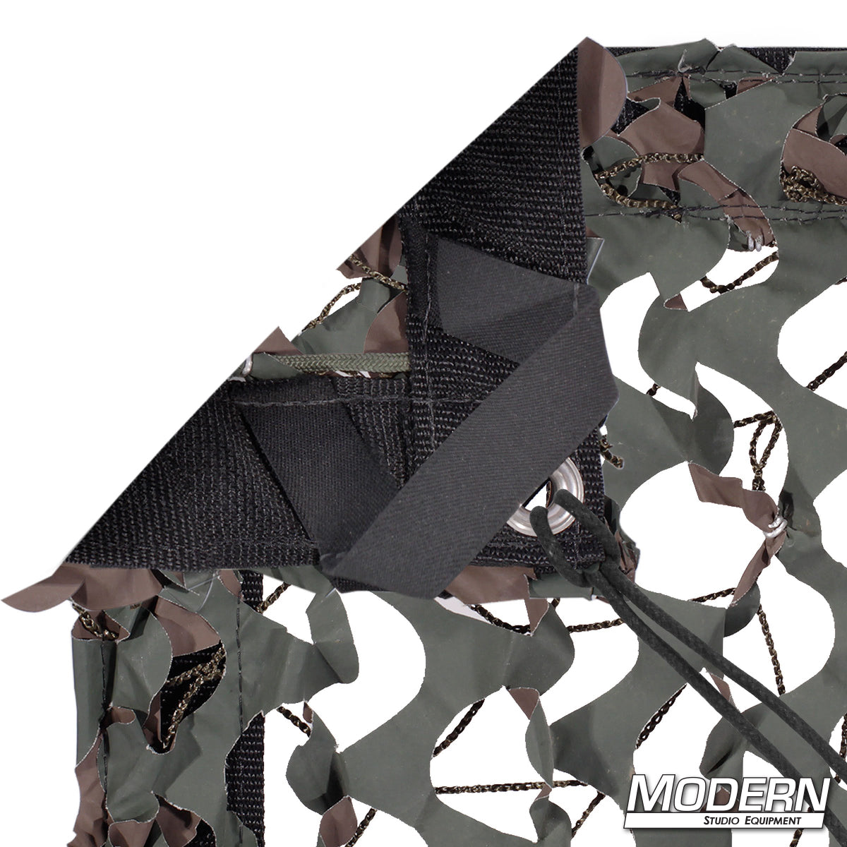 Camo Net slip-on textile with camouflage netting pattern, featuring webbing, grommets, ties, and elastic corners for film production and scenic applications