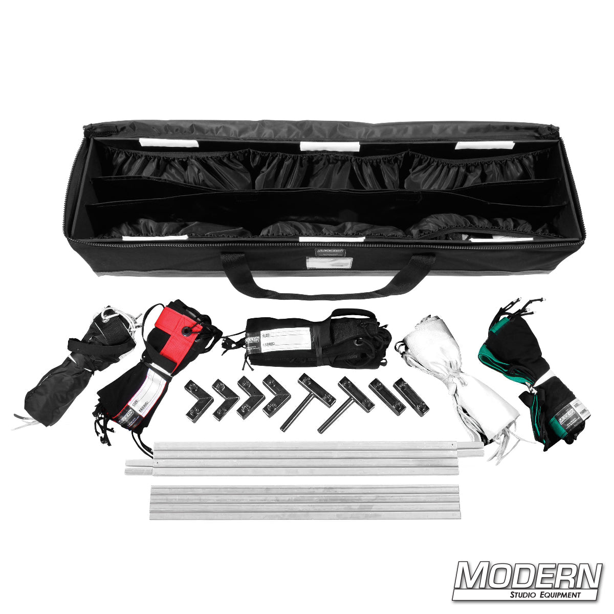 A collection of grip equipment for film sets displayed alongside a carrying bag, including flags, poles, and other accessories.